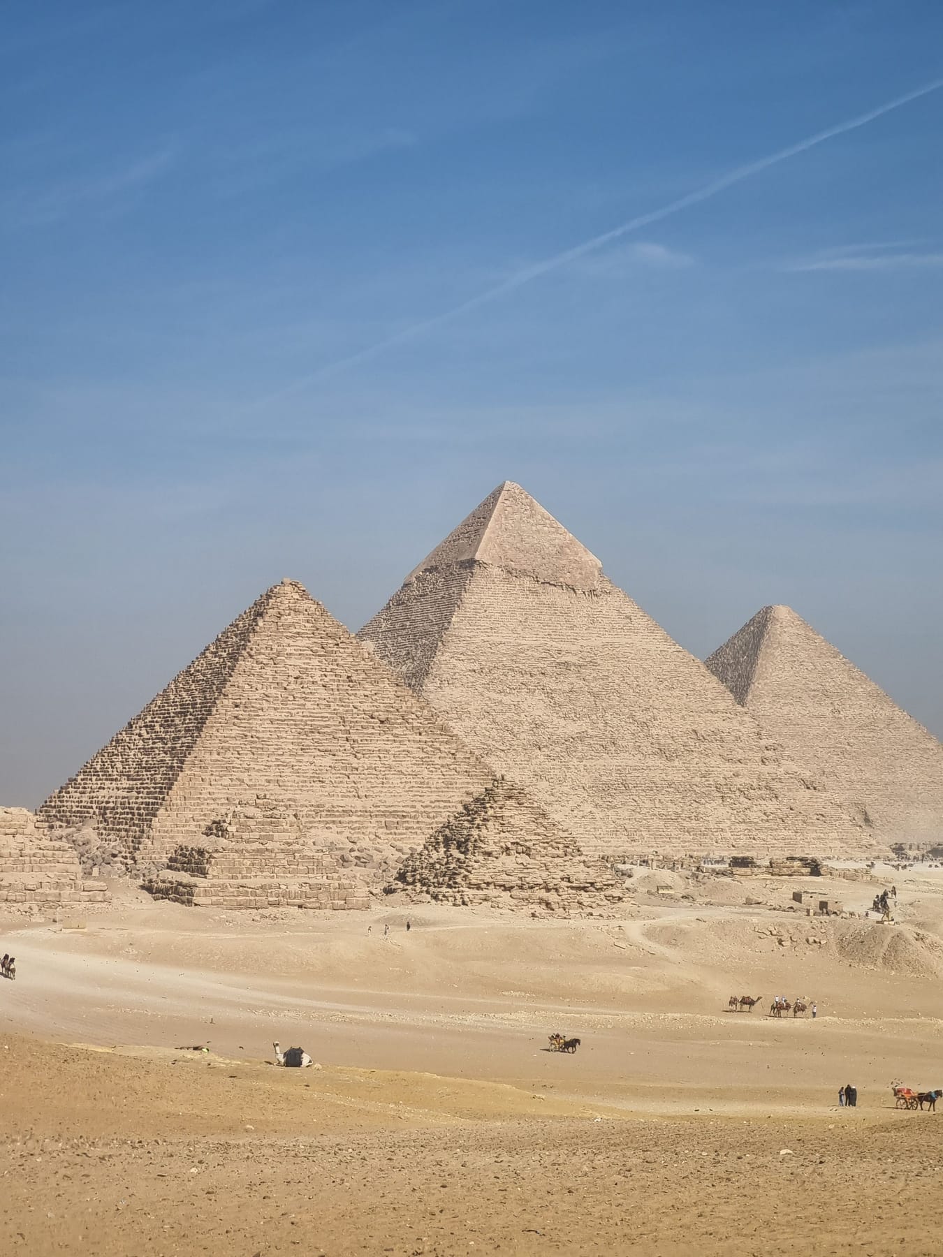 Pyramids of Giza under a blue sky